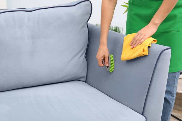 Woman cleaning couch  - Фото, зображення