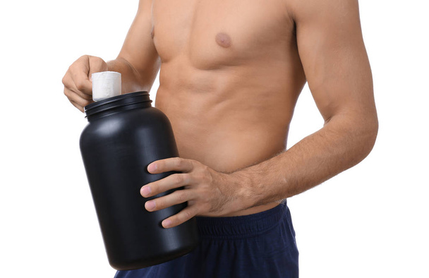 Shirtless young man holding protein powder - Foto, afbeelding