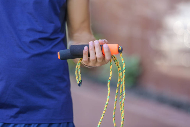 Young man holding jumping rope  - Φωτογραφία, εικόνα