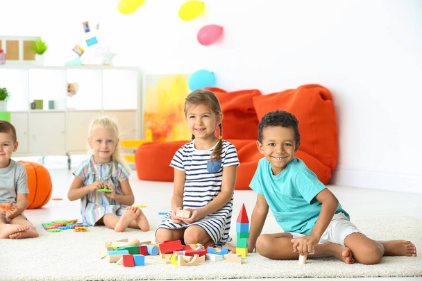 Cute children playing with blocks indoor - Fotoğraf, Görsel