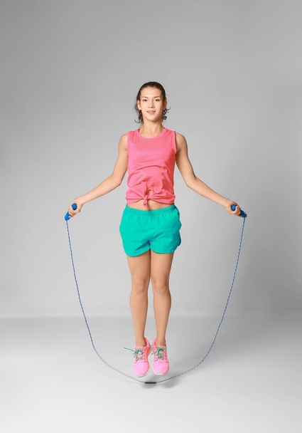 Young woman skipping rope  - 写真・画像