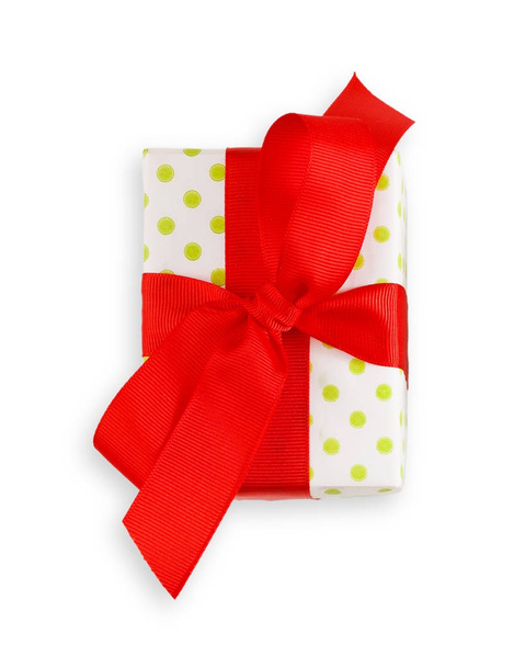 Gift box wrapped in white paper and red ribbon - Photo, image