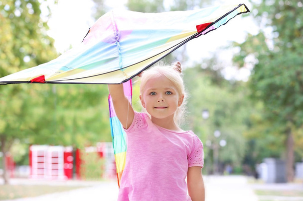 Cute little girl with colorful kite outdoors - Фото, зображення