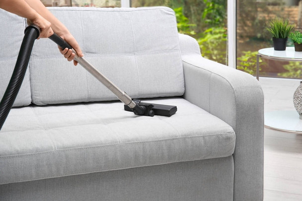 Woman cleaning couch  - Фото, зображення