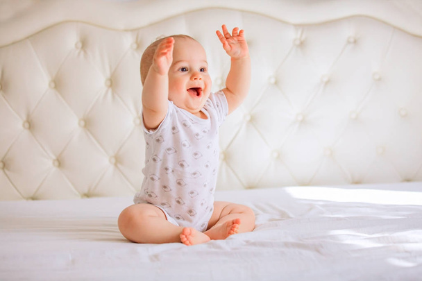 Cute baby boy in white sunny bedroom - Photo, image