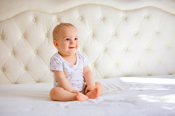 handsome baby boy in white sunny bedroom - Foto, Imagem