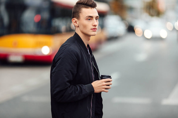Man walk on the street with cup of coffee - Photo, image