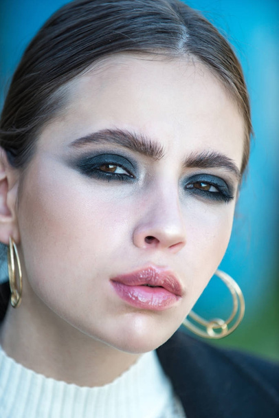 Girl or woman with makeup on face wear golden earrings - Fotó, kép