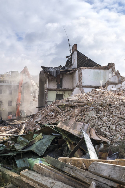 Demolition site with machine and wrecked houses - Photo, Image
