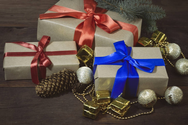 Gift boxes, golden balls, decorative gifts and beads, a branch o - 写真・画像