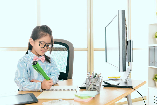 smiling female kid office worker using big pen - Foto, Imagen