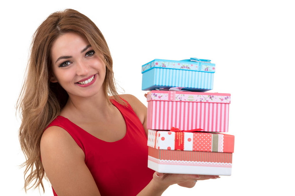Portrait of casual young happy smiling woman hold red gift box. Isolated studio background female model. - Fotó, kép