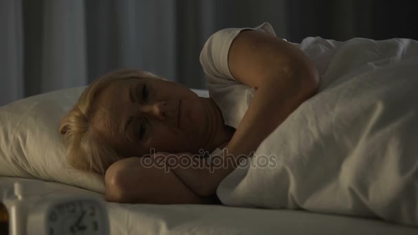Doomed and hopeless woman in depression lying in her bed at nursing home - Filmagem, Vídeo