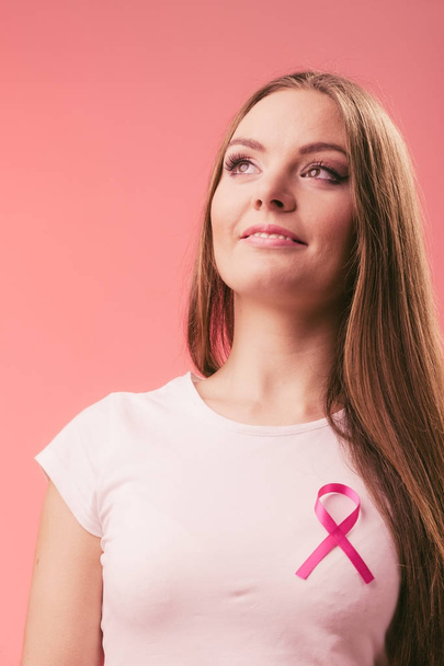 Woman wih pink cancer ribbon on chest - Foto, afbeelding