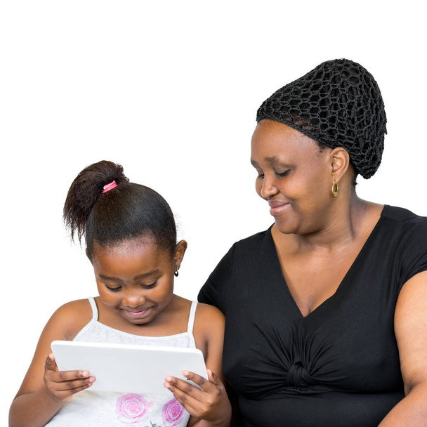African mother and little daughter looking at tablet together. - Foto, Imagem