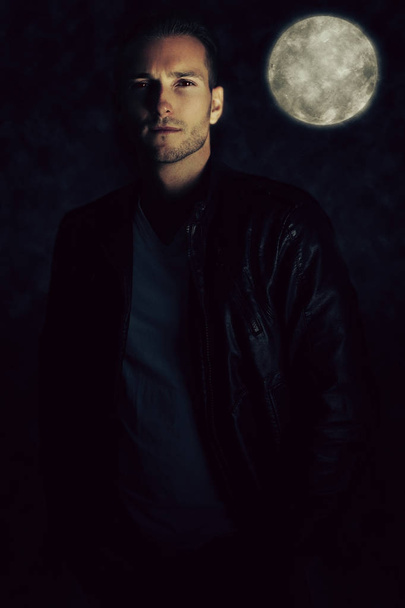 A vampire story. Handsome man wearing a leather jacket  - Фото, зображення
