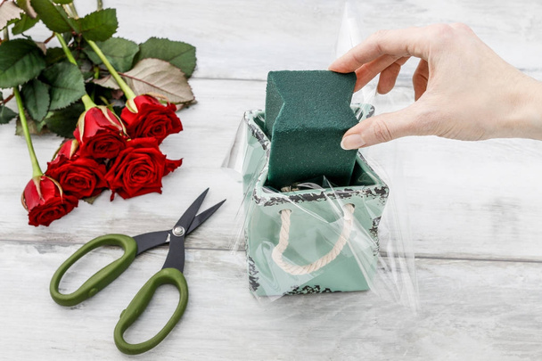 Florist workplace: how to make decoration with roses inside cera - Photo, image