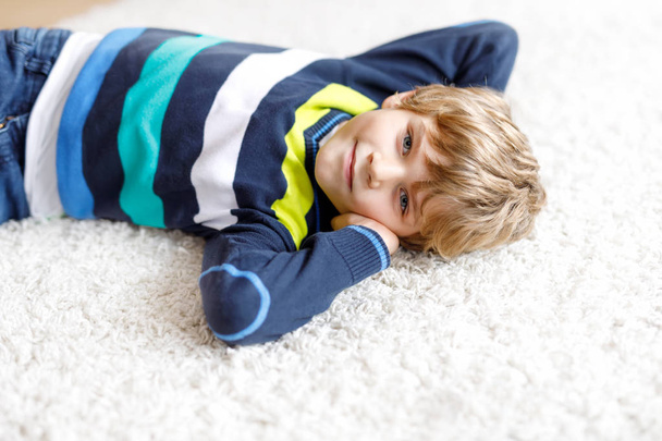 Portrait of little cute kid boy against white background. - Fotó, kép