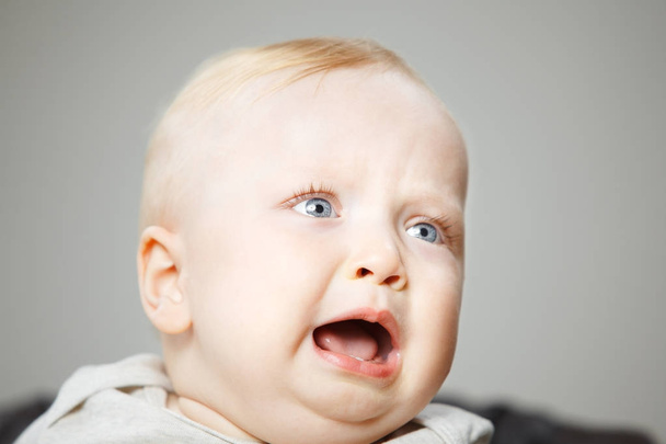 Disappointed blond baby boy cries hard portrait photo - Φωτογραφία, εικόνα