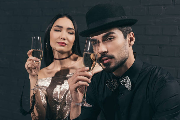 multiethnic couple with glasses of champagne - 写真・画像