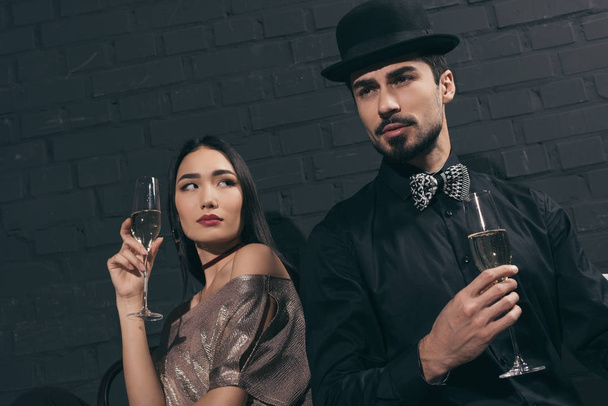 stylish multicultural couple with glasses of champagne - Foto, immagini