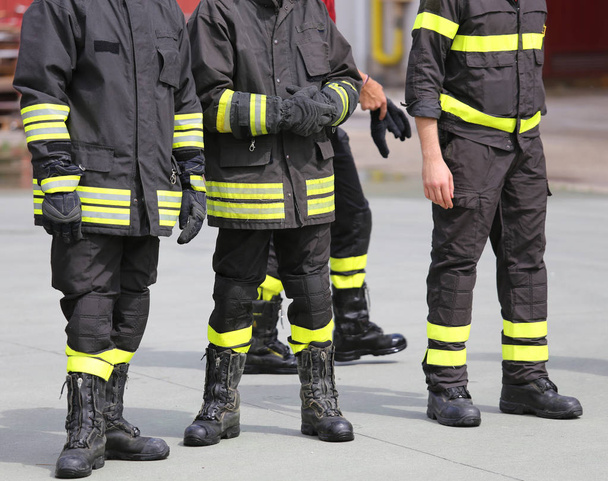 legs with boots of firemen after rescue mission - Photo, Image