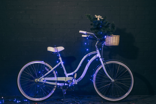 retro bicycle in christmas lights  - Photo, Image