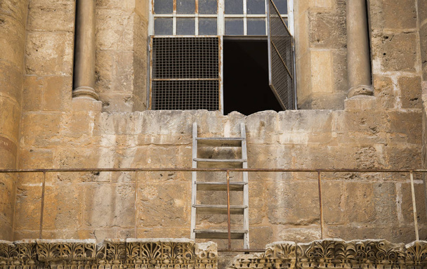 una escalera de madera se adjunta a la pared de una antigua piedra b
 - Foto, Imagen
