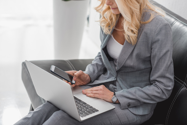 businesswoman using smartphone and laptop - Photo, Image