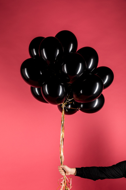 woman holding black balloons - Photo, image