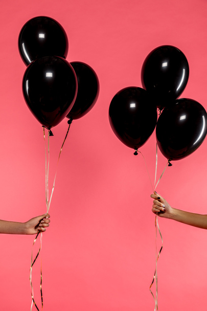 black balloons in hands - Foto, Imagen