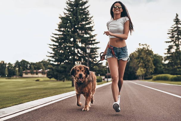woman in jeans shorts running - Фото, изображение