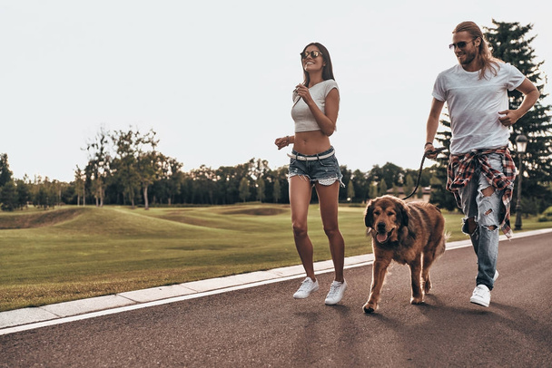 couple in love with big dog running - Valokuva, kuva