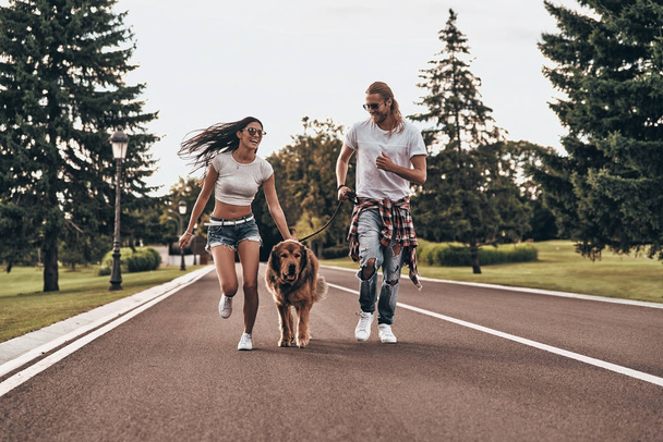 couple in love with big dog running - Foto, Imagem