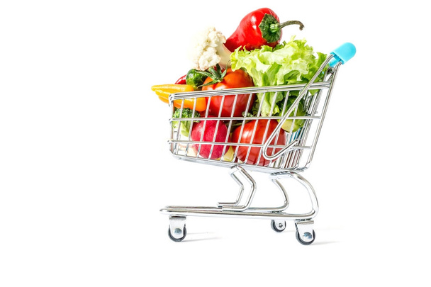 Shopping cart with fresh vegetables close-up isolated on white background - Foto, Imagen
