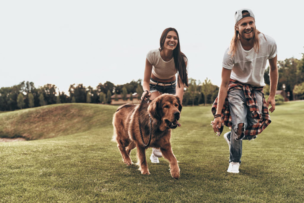 couple in love with big dog running - Photo, Image