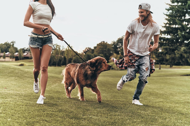 couple with big dog running - Foto, afbeelding