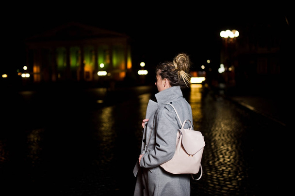 Girl with dreadlocks walking at night street of city. - Foto, imagen