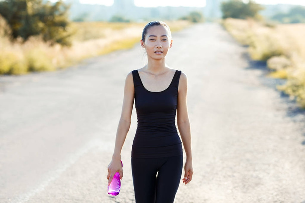 woman carrying water bottle - Photo, Image