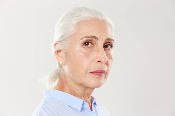 Side view photo of serious mature woman, looking at camera - Foto, immagini