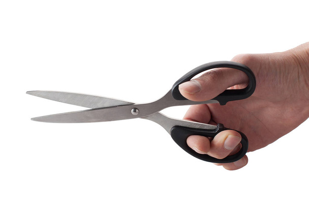 Hand with scissors on isolated white background. - Zdjęcie, obraz