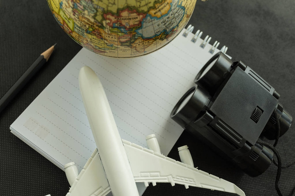 World travel concept with toy airplane, and binoculars on white  - Foto, imagen
