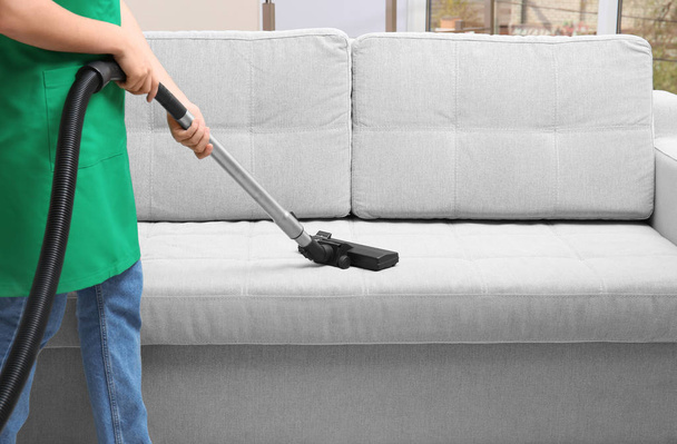 Woman cleaning couch  - Fotó, kép