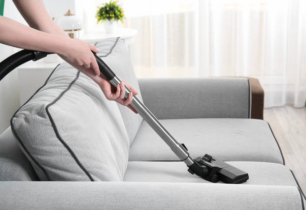 Woman cleaning couch  - Valokuva, kuva