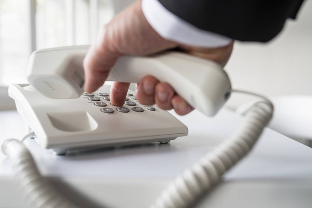 Businessman dialing a telephone number - Photo, Image