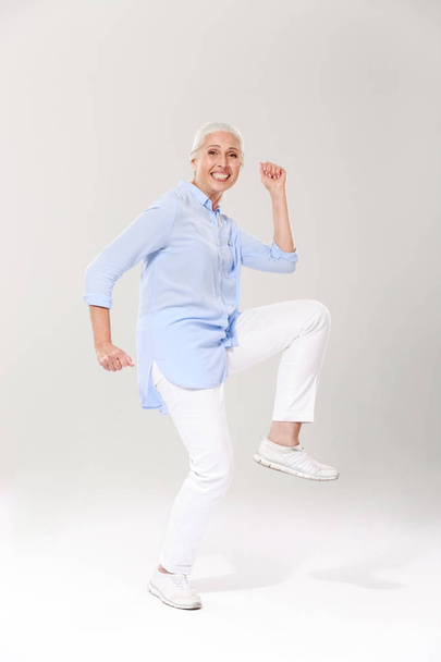 Full-length photo of playful old lady, having fun over white bac - Foto, Imagen