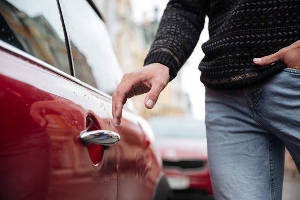 Close up portrait of a male hand at the car handle outdoors - 写真・画像