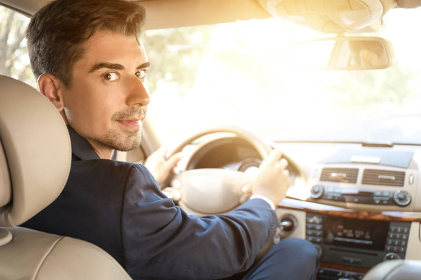 Young businessman driving a car - Foto, immagini