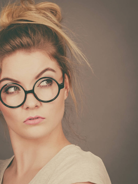 Bored focused teenage woman wearing eyeglasses - Foto, Imagem