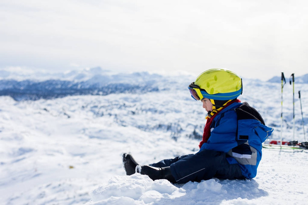 Cute little boy, skiing happily in Austrian ski resort in the mo - Photo, image